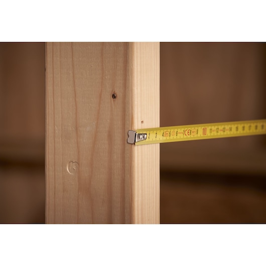 STANLEY 0-32-109 tape measure photography showing yellow tape against wooden beam.