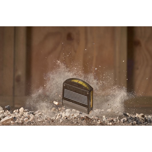 STANLEY 0-32-125 tape measure photography, close-up with dust and debris in construction setting.
