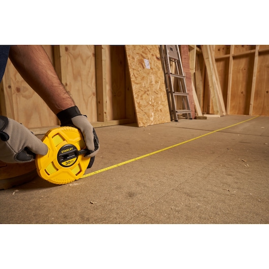 Photo of STANLEY 0-34-297 measuring tape being used on a construction site floor.
