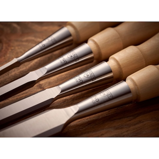 STANLEY 1-16-793 woodworking chisels with wood handles, close-up angle on wooden surface.