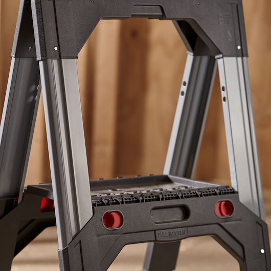 STANLEY 1-92-980 step ladder, side angle, black and silver with red details, shown in indoor setting.