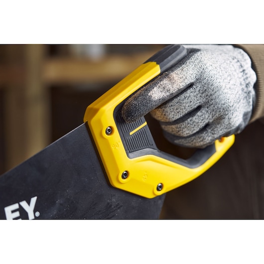 STANLEY 2-20-180 hand saw close-up, yellow and black handle with gloved hand, photography.