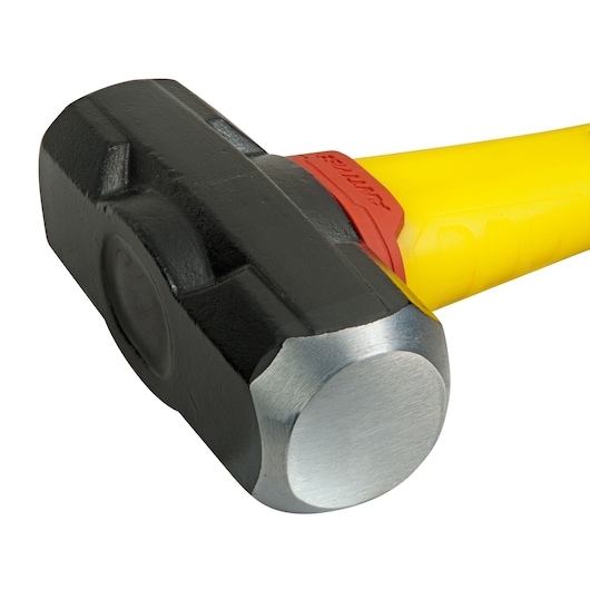 Close-up of a STANLEY sledgehammer with a black head and yellow handle.