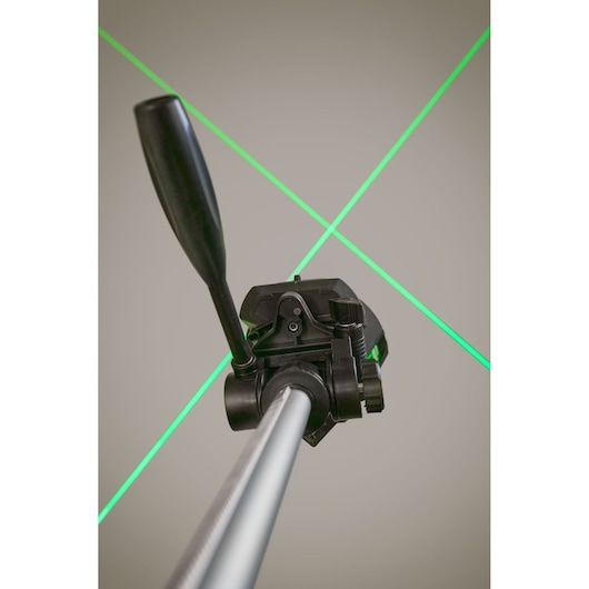 STANLEY FMHT1-77356 laser level on tripod projecting green cross lines, photography close-up view.