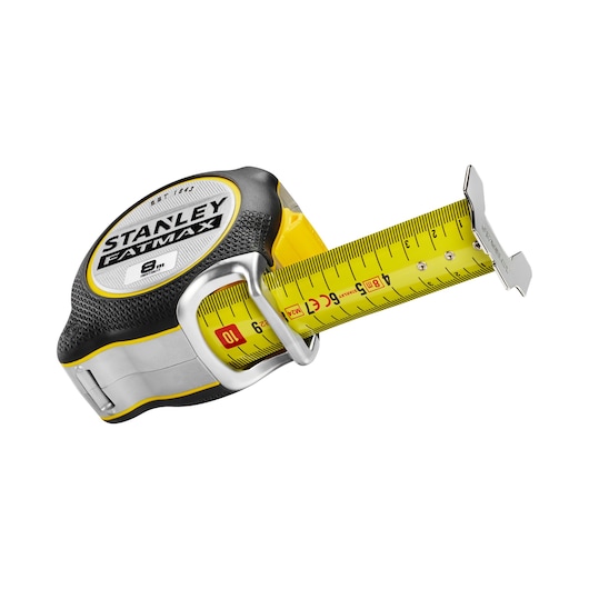STANLEY FMHT38217-0 tape measure, yellow and black, with extended blade, photography, angled view on white background.