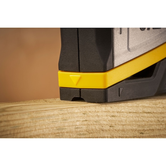 STANLEY FMHT70401-0 photography of black and yellow tool detail, close-up angle on wood surface.