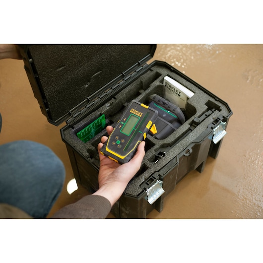 Photo of STANLEY FMHT77653-0 electronic detector kit in a black foam-lined case, handheld and accessories visible.
