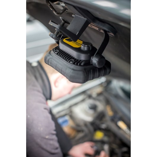 STANLEY FMHT81507-1 work light mounted under car hood, illuminating engine area during repair.