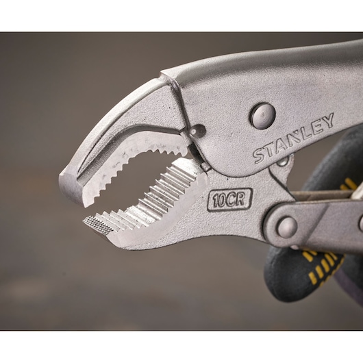 Close-up of a STANLEY locking plier with serrated jaws and 10CR marking, used for gripping or clamping objects.