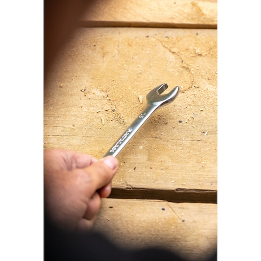 Photo of STANLEY FMMT13029-0 open-ended wrench held over a wooden surface.