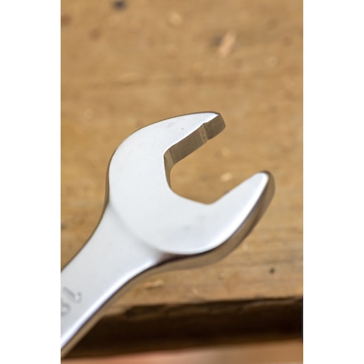 STANLEY FMMT13029-0 open-end wrench, close-up view, silver finish, placed on a wooden surface.