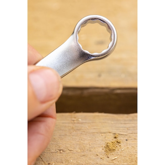 STANLEY FMMT13033-0 box-end wrench close-up held by hand, silver finish, photography category.