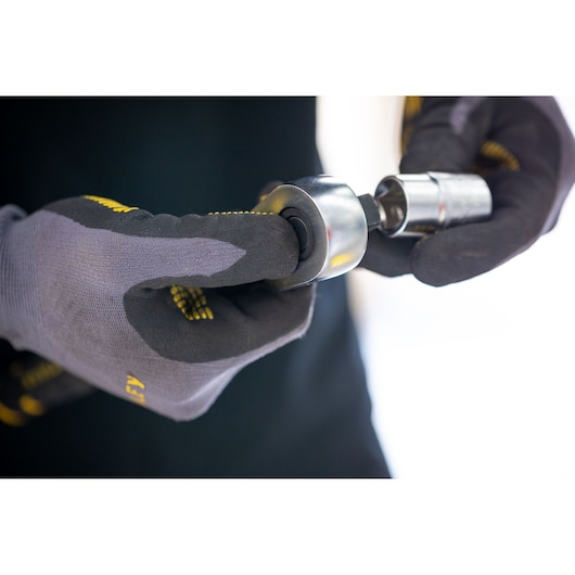 Photo of STANLEY FMMT17234-0 socket tool held by gloved hands, close-up view, tool category.