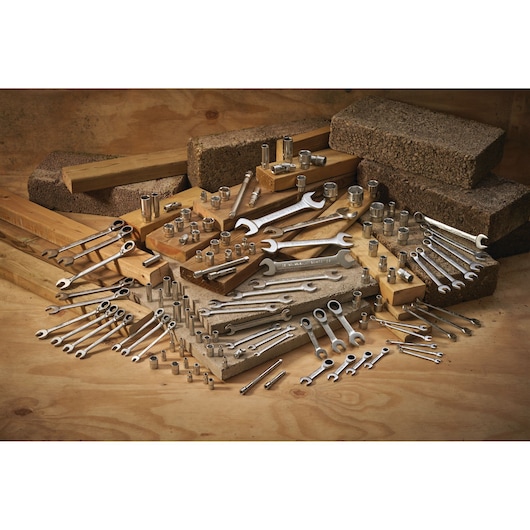 STANLEY FMMT17246-0 hand tool set with various wrenches and sockets arranged on wood and brick.