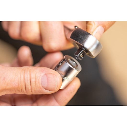 STANLEY FMMT82679-0 ratchet and socket, close-up, silver finish, held by hand.