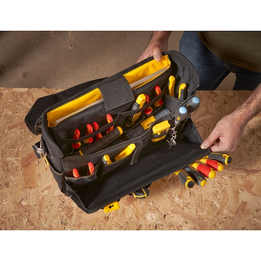 STANLEY FMST1-80149 tool bag filled with hand tools, black and yellow, top angle photo.