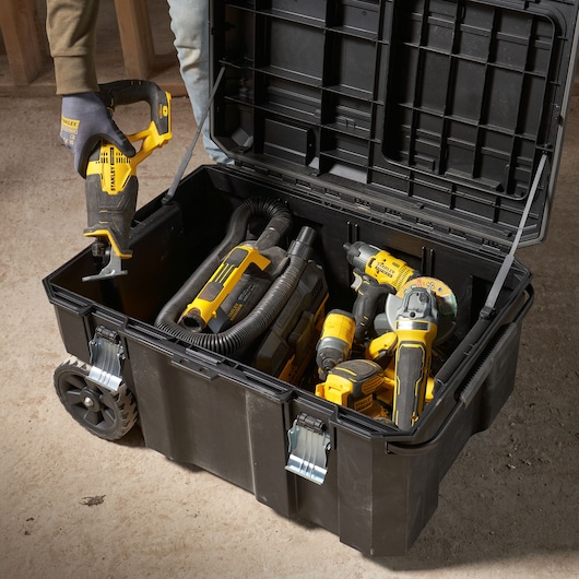 Photo of STANLEY FMST17870-1 rolling tool box open, filled with various power tools, shown from above.