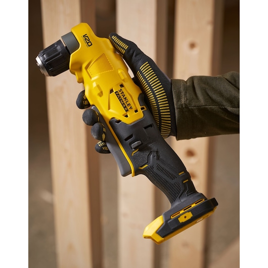 STANLEY SFMCD750D2K cordless angle drill held in gloved hand, close-up showing yellow and black design.