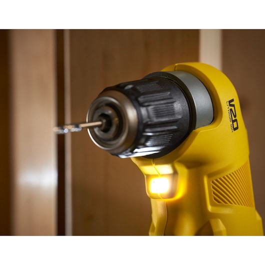 Close-up photo of STANLEY SFMCD750D2K cordless drill with LED light on, yellow body, drill bit inserted.