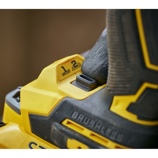 Close-up of a yellow and black STANLEY brushless power tool with a two-speed selector switch.