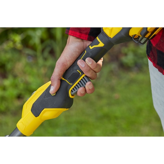 STANLEY SFMCSTB933M string trimmer handle close-up held by hand, black and yellow finish.