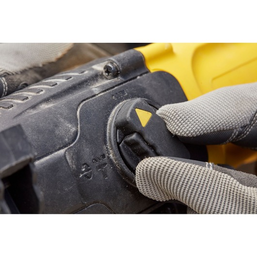 STANLEY SFMEH210K-QS rotary hammer mode selector close-up with gloved hand turning dial.