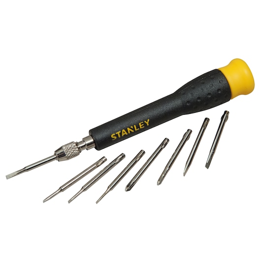 Stanley precision screwdriver with yellow handle and seven interchangeable bits arranged beside it.