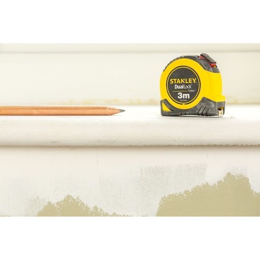 STANLEY STHT36802-0 tape measure and pencil on white background, front angle.