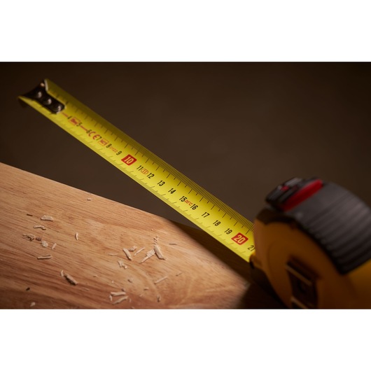 STANLEY STHT36804-0 tape measure extended on wood surface, close-up photography.