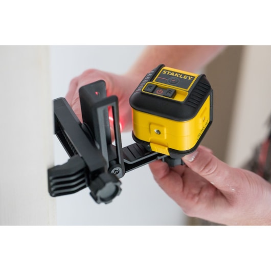 STANLEY STHT77502-1 yellow and black laser level mounted on adjustable bracket, in use.