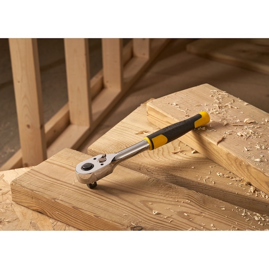 Photo of STANLEY STMT82665-0 72-Tooth Ratchet tool with yellow and black handle on wooden workbench.