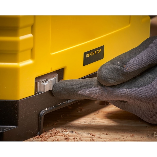 STANLEY STP18-B2 photography of depth stop adjustment on yellow woodworking tool, close-up angle.