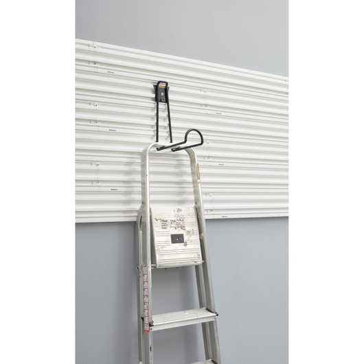 STANLEY STST82614-1 ladder hanging hook on white wall panel, front angle.